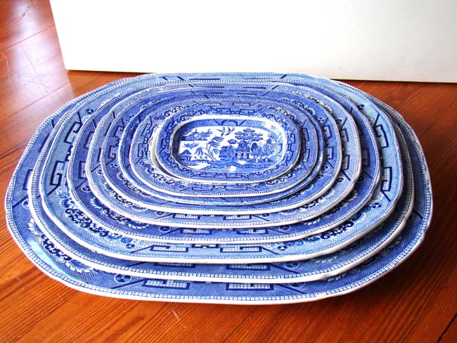 An Assembled and Graduated Set of Nine English Willow Pattern serving Platters circa 1880-1920
